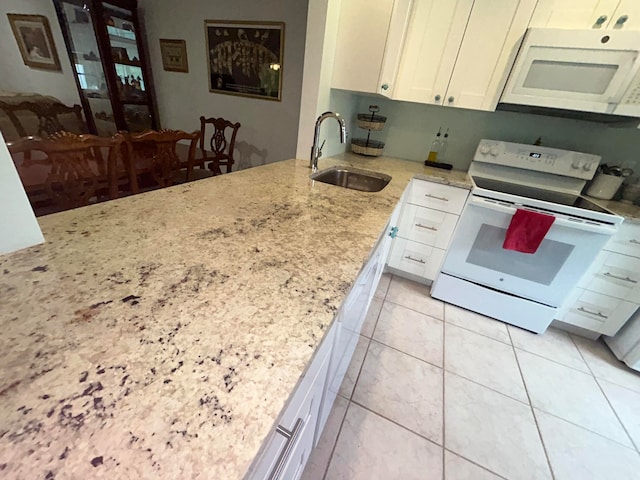 kitchen with white cabinetry, white appliances, sink, and light tile flooring