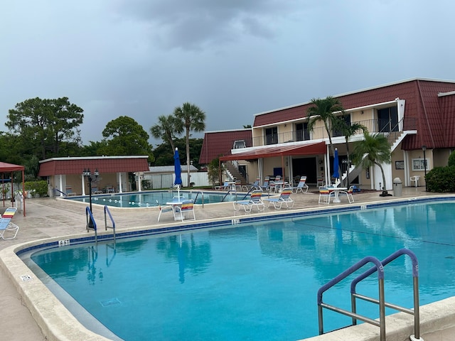 view of swimming pool featuring a patio area