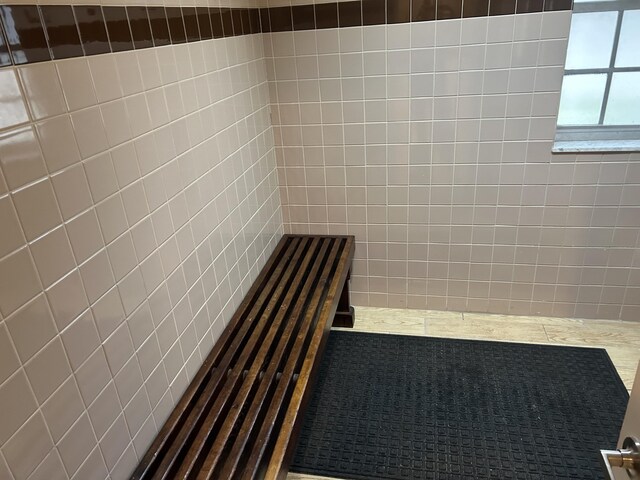 bathroom with tile walls