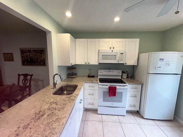 kitchen with ceiling fan, white cabinetry, sink, white appliances, and light tile floors