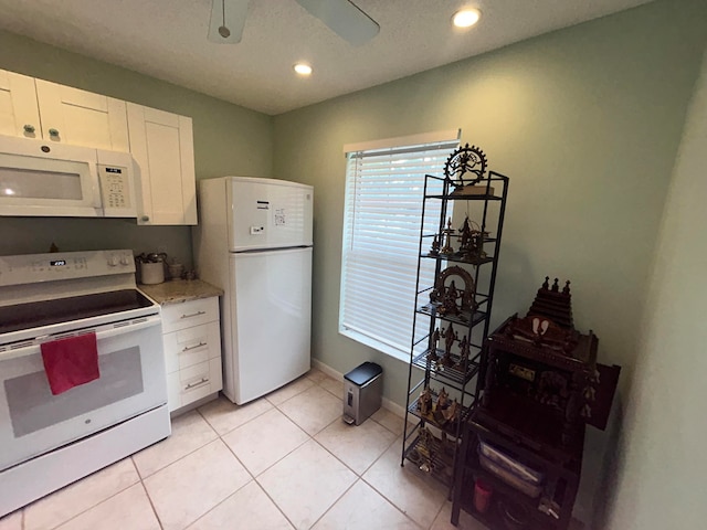 kitchen featuring ceiling fan, white appliances, white cabinetry, and light tile floors