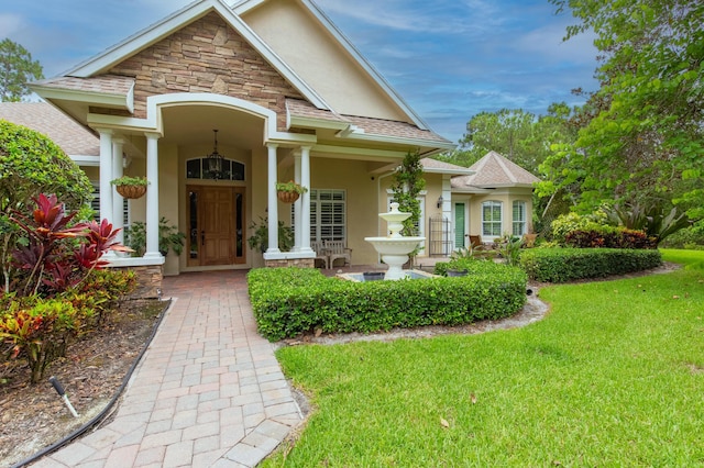 view of exterior entry featuring a yard