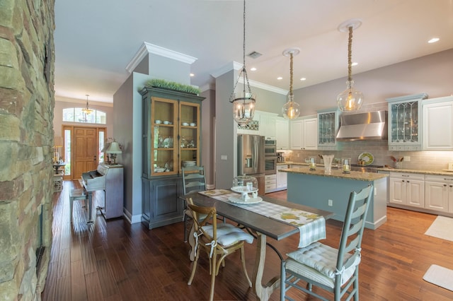 dining space featuring dark hardwood / wood-style flooring and ornamental molding