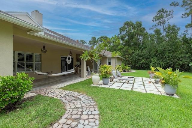 view of yard featuring a deck and a patio