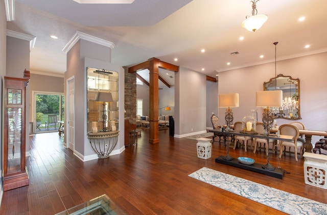 interior space with ornate columns, ornamental molding, and dark hardwood / wood-style floors