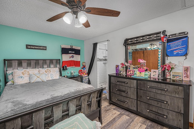 bedroom featuring a textured ceiling, ceiling fan, and hardwood / wood-style floors