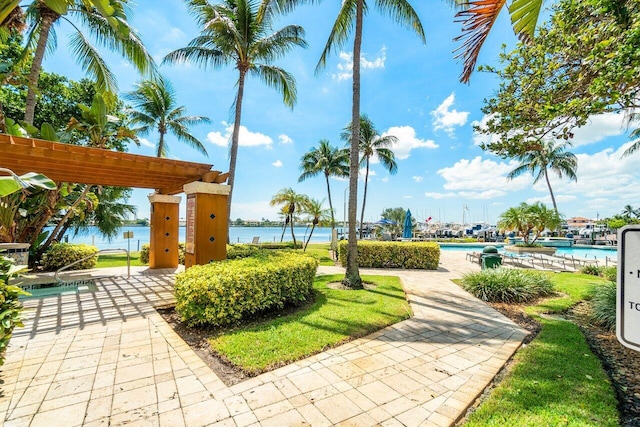 127 Yacht Club Way Unit 206, Hypoluxo, FL 33462 - surrounding community with a water view and a swimming pool