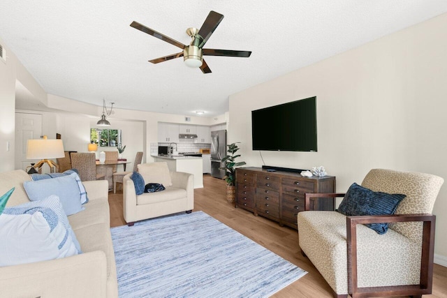 127 Yacht Club Way Unit 206, Hypoluxo, FL 33462 - living area featuring light wood-type flooring, visible vents, and a ceiling fan