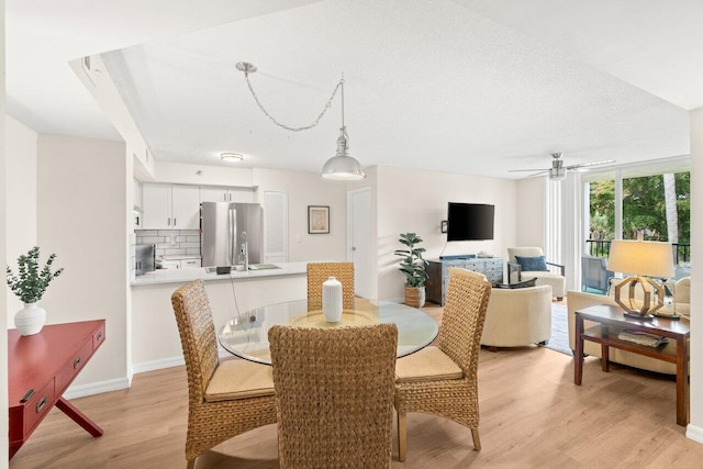 127 Yacht Club Way Unit 206, Hypoluxo, FL 33462 - dining area with ceiling fan and light wood-type flooring