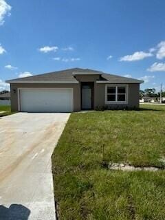 view of front of house featuring a garage and a front lawn