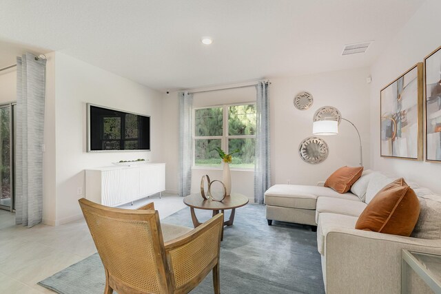 tiled dining space with an inviting chandelier