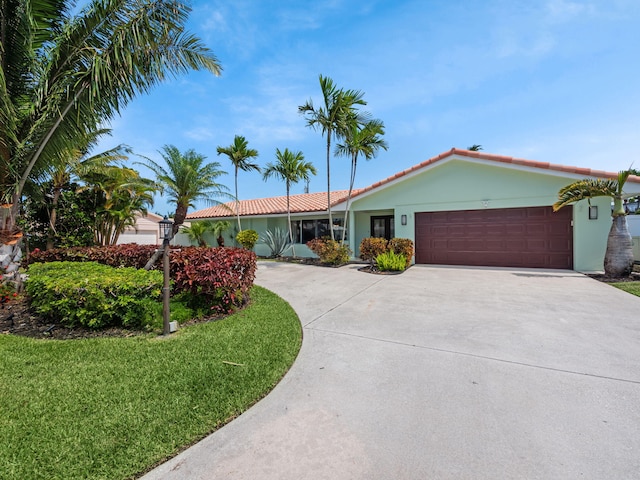 single story home with a front lawn and a garage