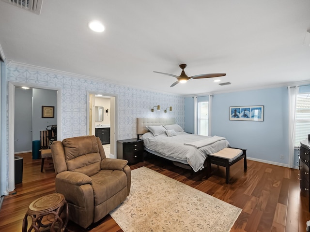 bedroom with ensuite bath, ceiling fan, dark hardwood / wood-style flooring, and ornamental molding