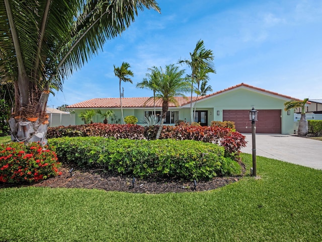 single story home with a front lawn and a garage