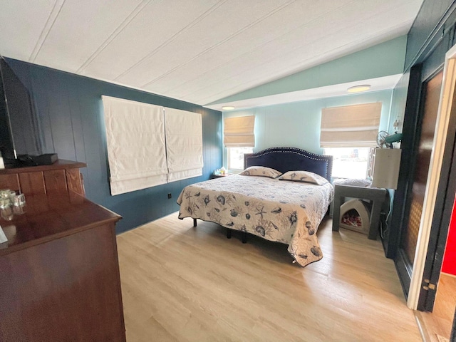 bedroom with vaulted ceiling and wood-type flooring