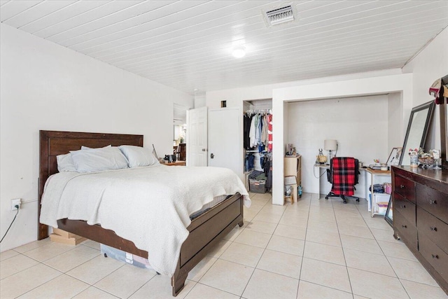 bedroom with light tile patterned floors and a closet