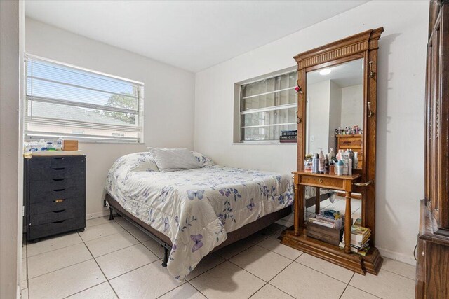 bedroom with light tile patterned floors and wood ceiling