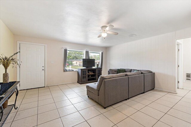 living room featuring ceiling fan and light tile patterned flooring