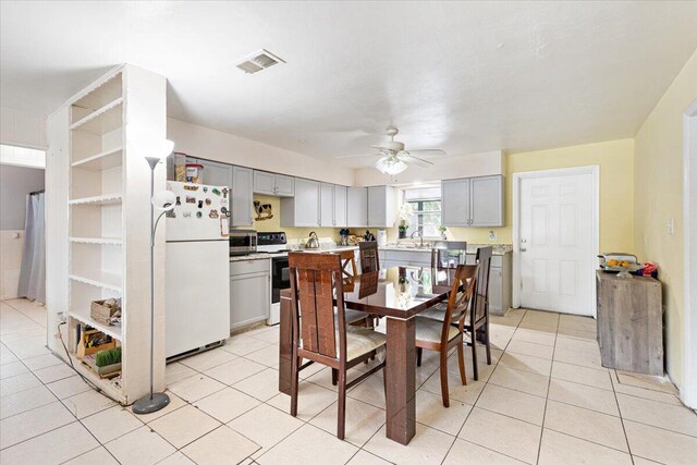 tiled dining space featuring ceiling fan