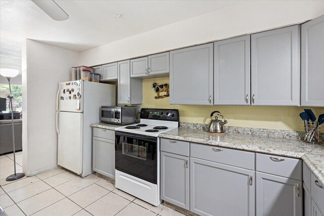 kitchen featuring gray cabinets, sink, and light tile patterned flooring