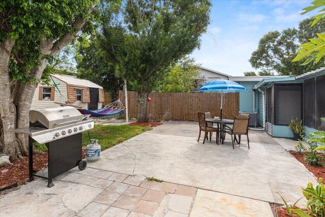 view of patio / terrace with area for grilling and a sunroom