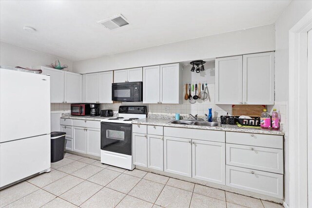 kitchen featuring white cabinets, decorative backsplash, electric stove, and sink