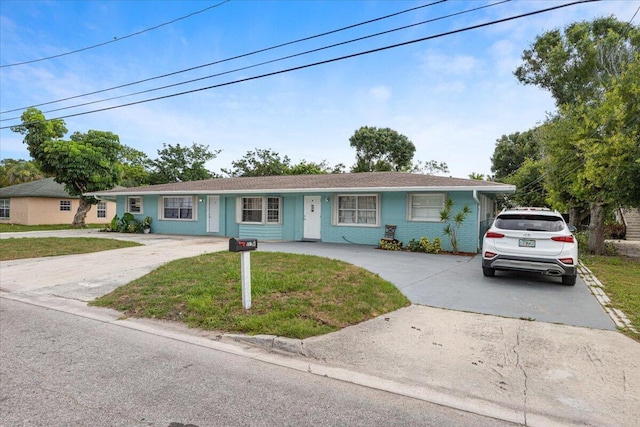 ranch-style home with a front lawn