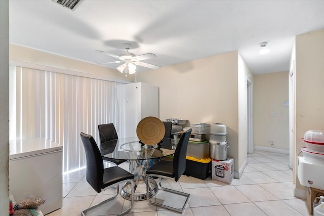 tiled dining area featuring ceiling fan