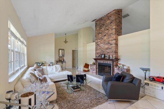 living room with light tile floors, brick wall, a brick fireplace, and vaulted ceiling