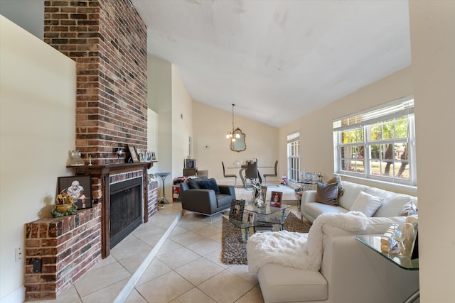 living room with vaulted ceiling, a fireplace, light tile flooring, and brick wall