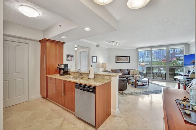 kitchen with a textured ceiling, light stone counters, stainless steel dishwasher, and rail lighting