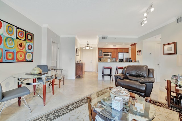 living room with crown molding, track lighting, and light tile floors