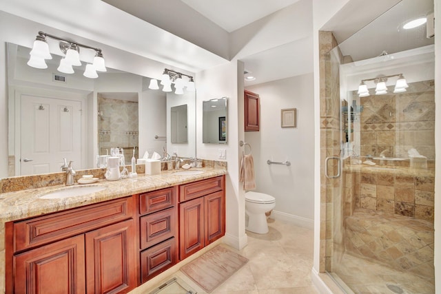 bathroom with toilet, tile flooring, an enclosed shower, and double sink vanity