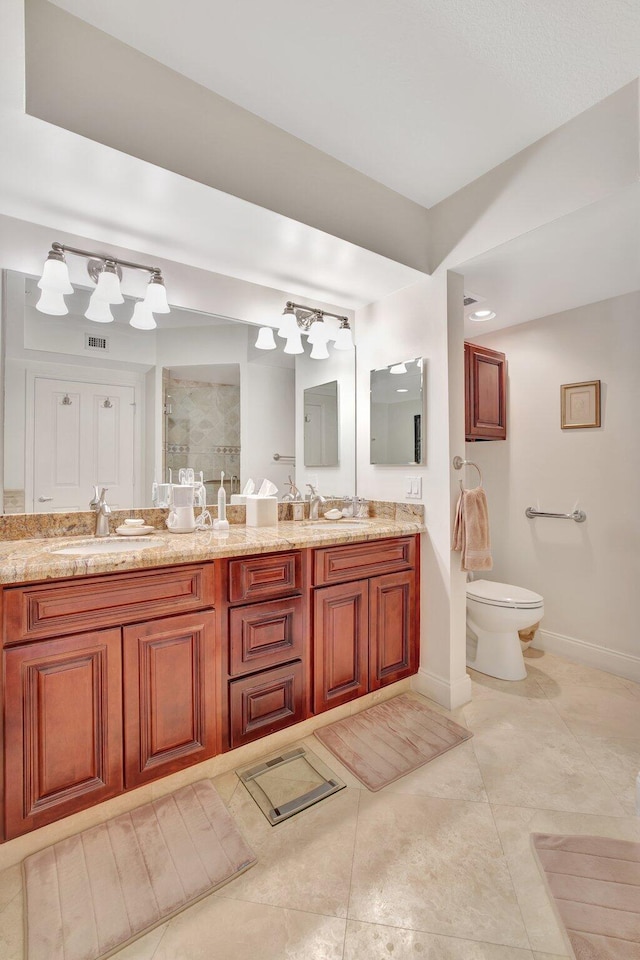 bathroom featuring tile flooring, double sink vanity, and toilet