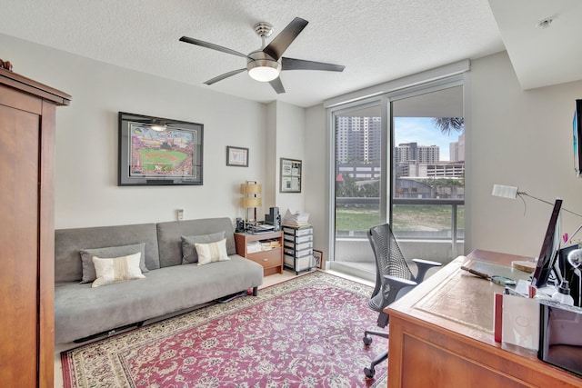 office featuring a textured ceiling and ceiling fan