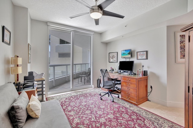 tiled office space with ceiling fan and a textured ceiling