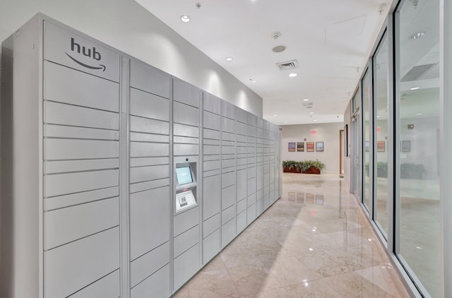 hallway featuring light tile flooring and a package area