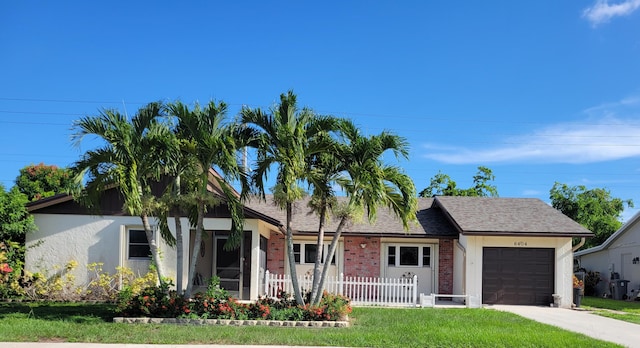 view of front facade with a front yard and a garage