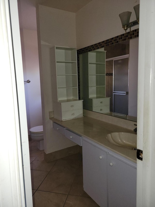 bathroom featuring tile patterned flooring, vanity, and toilet