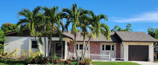 view of front of property with a garage and a front lawn