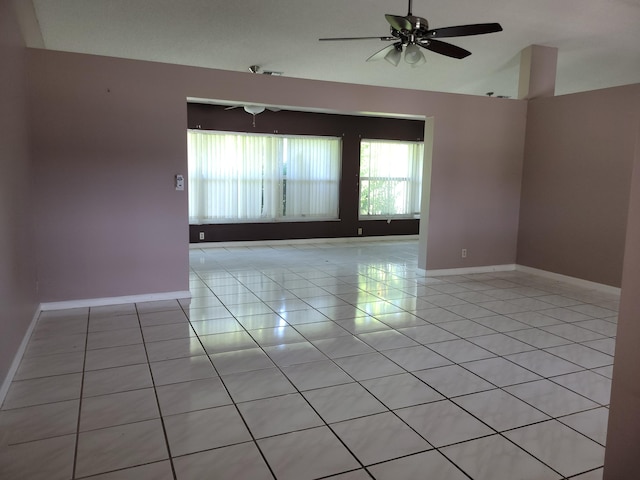 unfurnished room with ceiling fan and light tile patterned floors