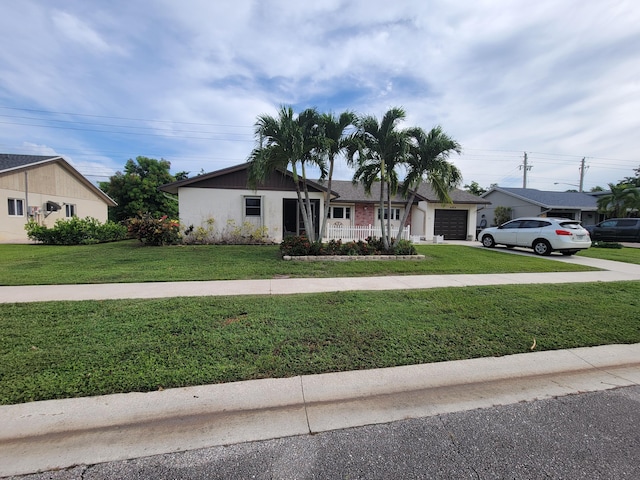 ranch-style house featuring a garage, a front lawn, and a porch