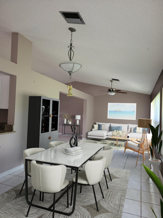 tiled dining area featuring ceiling fan, a textured ceiling, and vaulted ceiling