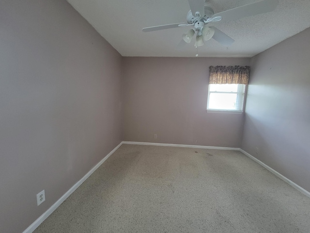 spare room with carpet flooring, ceiling fan, and a textured ceiling