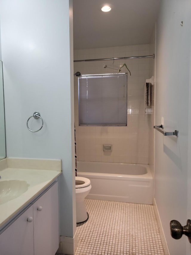 full bathroom with toilet, vanity, tile patterned floors, and tiled shower / bath combo