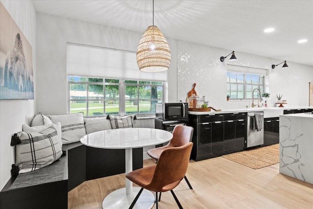 dining room with plenty of natural light and light hardwood / wood-style flooring