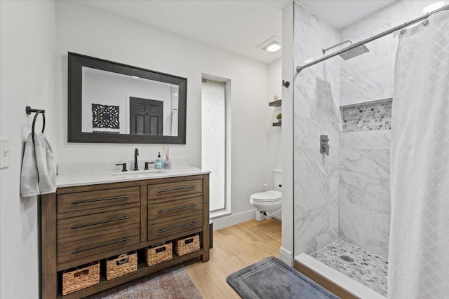 bathroom with toilet, vanity, a shower with curtain, and wood-type flooring