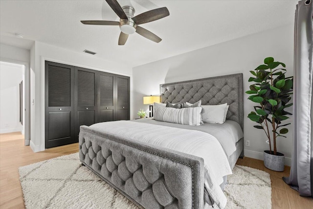 bedroom featuring ceiling fan, a closet, and light hardwood / wood-style flooring