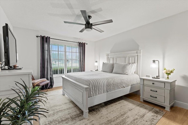 bedroom with ceiling fan and light wood-type flooring