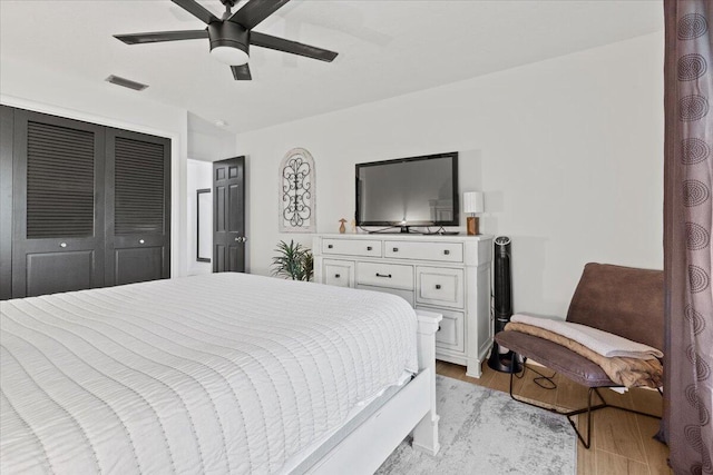 bedroom featuring ceiling fan, a closet, and light wood-type flooring